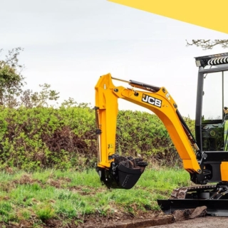 Der Minibagger baggert ein Loch am Rand einer Straße. - Minibagger selber fahren in Wuppertal