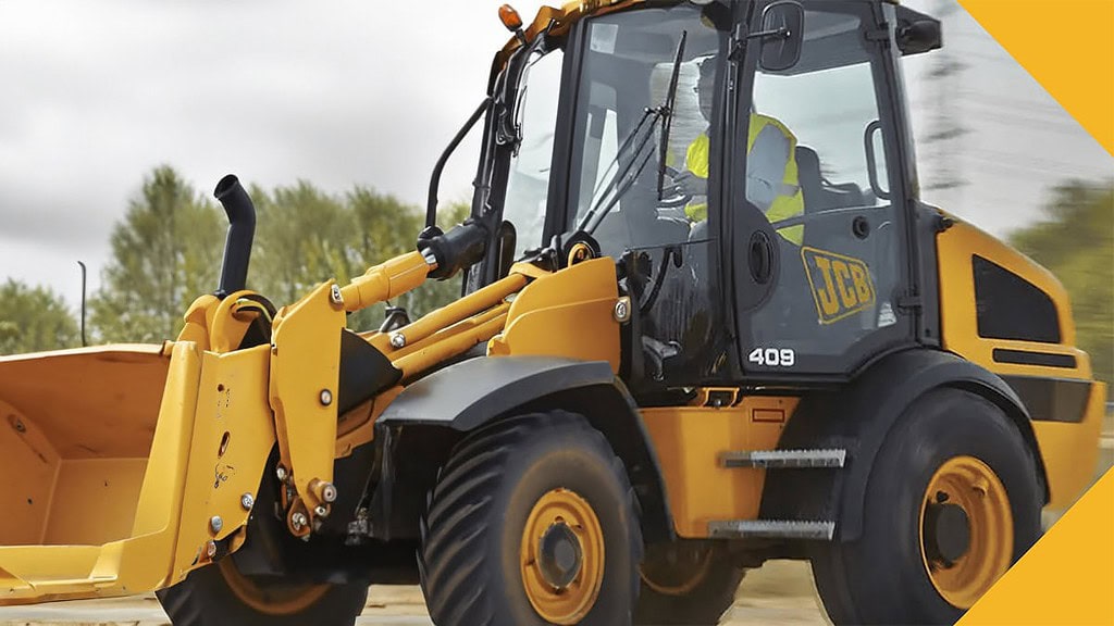 Radlader1.jpg Ein Radlader fährt auf einer Baustelle entlang. - Radlader selber fahren in Wuppertal