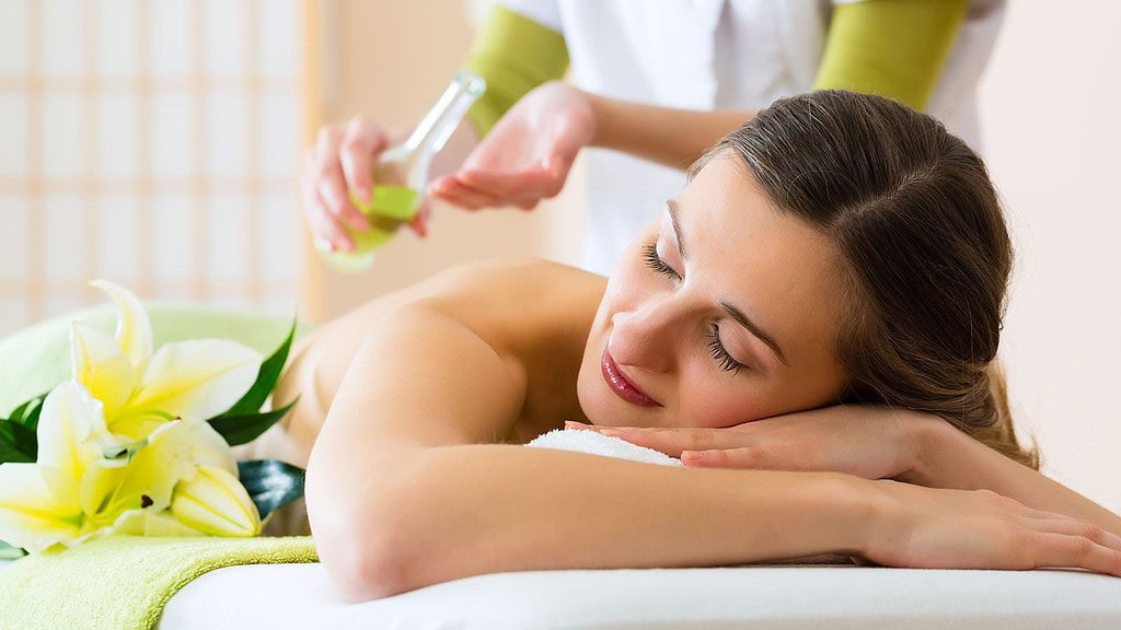 woman having wellness back massage in spa
