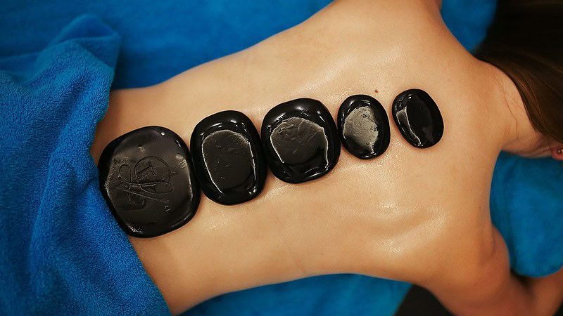 Massagestein auf dem Rücken bei der Hot Stone Massage in Dresden