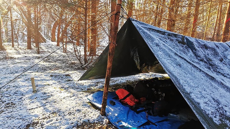 Verschneites Tarp im Wald.
