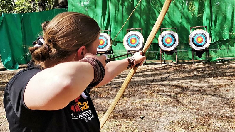 Frau beim Bogenschießen.
