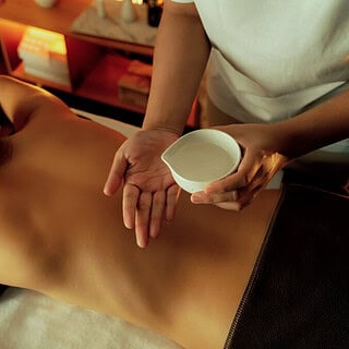 Eine Frau genießt verschiedene Techniken einer Ganzörpermassage mit Öl