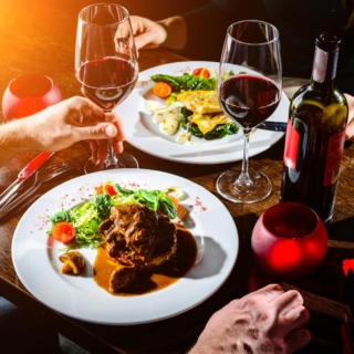 erlebnis-dinner (2) üppiges Abendessen mit Rotwein in einem Restaurant, von oben fotografiert