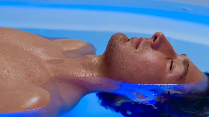 Ansciht von der Seite wie ein Mann auf dem Wasser liegt beim Floating in Stuttgart